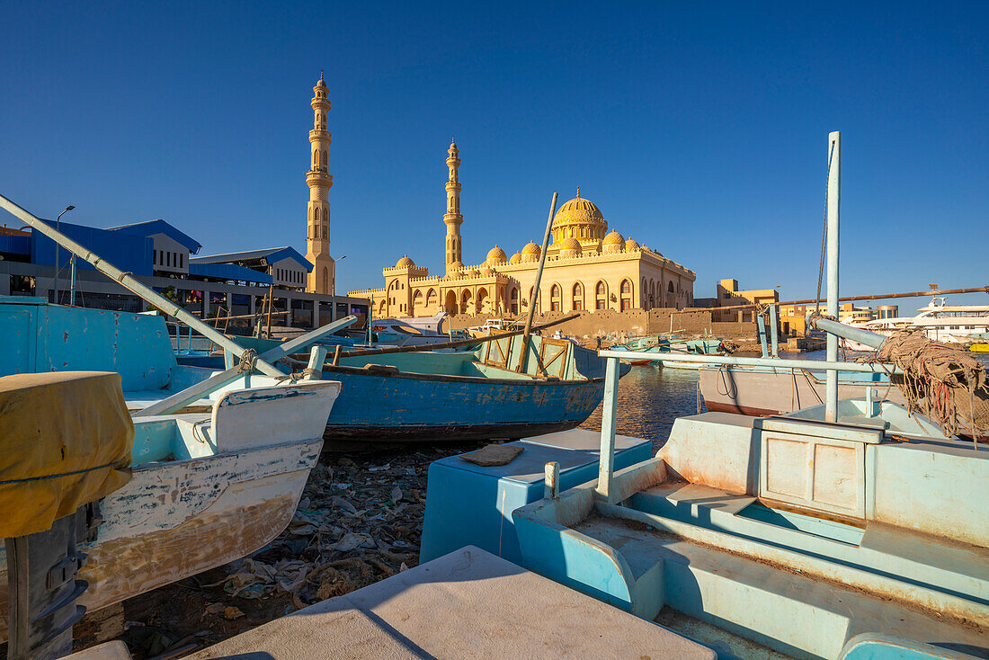 View of colourful wooden boats in Hurghada Harbour and Al Mina Mosque in background, Hurghada, Red Sea Governorate, Egypt, North Africa, Africa