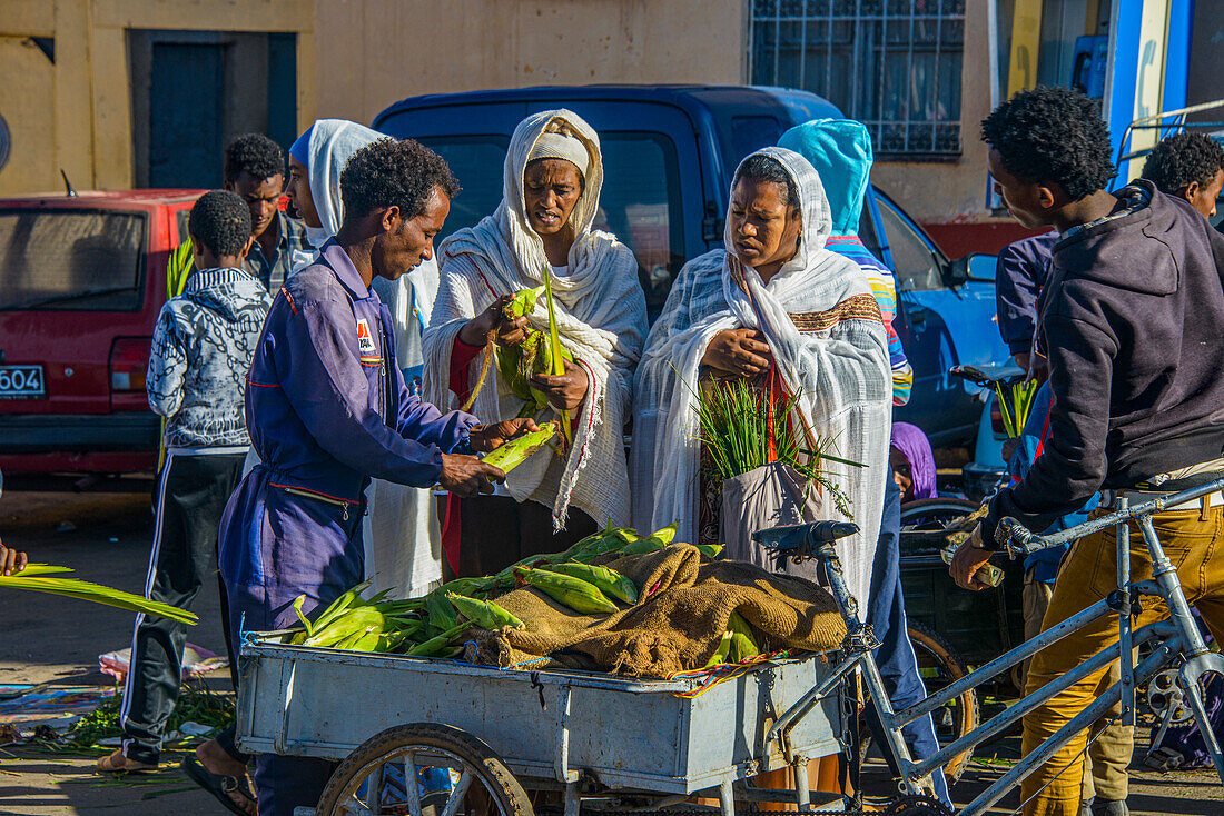 Orthodox dressed woman buying vegetables, Asmara, Eritrea, Africa