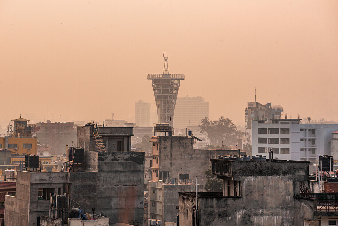 Orange sunrise view over the roof tops in Thamel showing Skywalk Tower Kamaladi, Kathmandu, Nepal, Asia