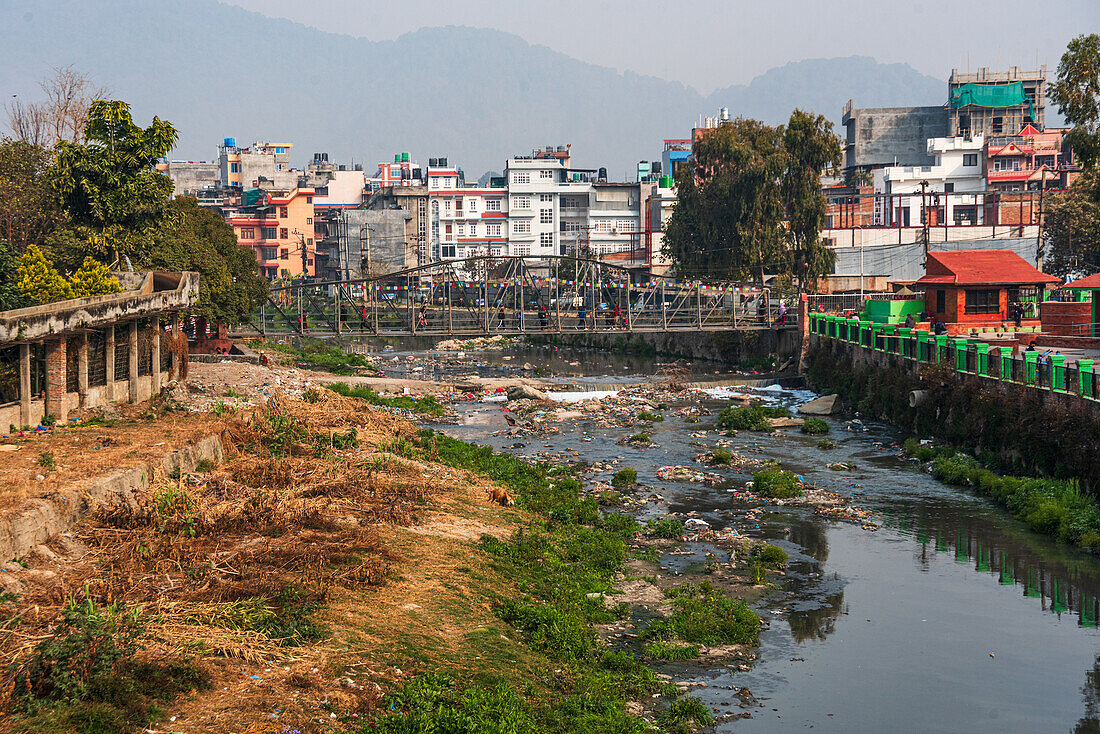 View across the polluted Bishnumati River in Kathmandu, Nepal, Asia