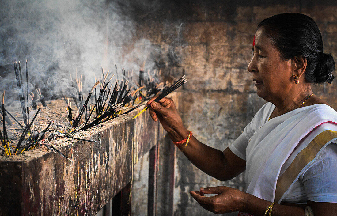 Woman devotee with incense sticks, Kamakhya Temple, Guwahati, Assam, India, Asia