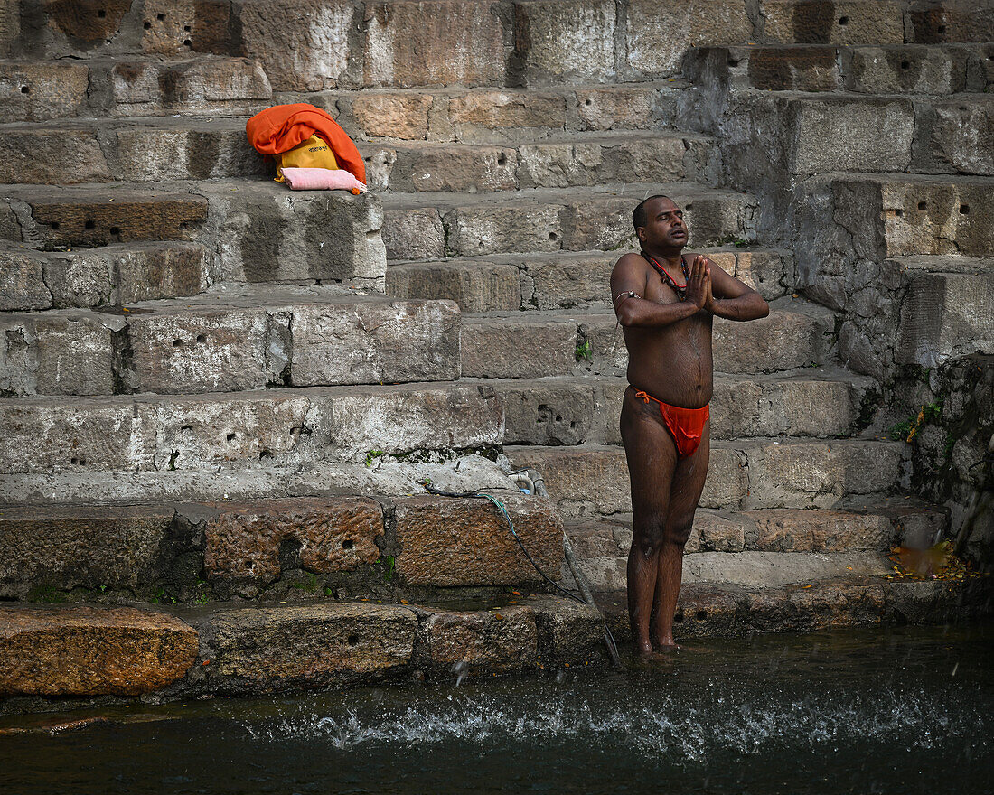 Man praying before bathing, Kamakhya Temple, Guwahati, Assam, India, Asia