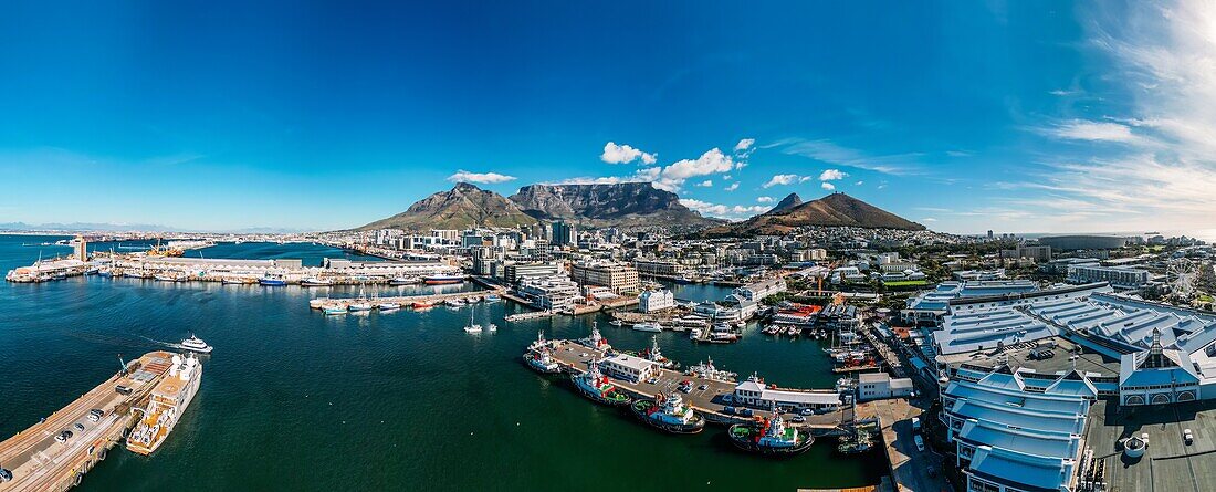 Aerial drone panoramic view of the V and A (Victoria and Alfred) Waterfront, a mixed-use destination located in the oldest working harbour in the Southern Hemisphere,with Table Mountain as backdrop, Cape Town, Western Cape, South Africa, Africa