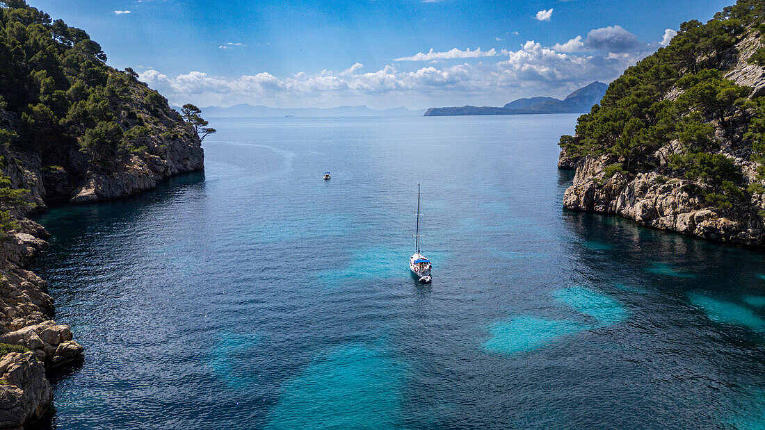 Aerial of a little sailingboat in a bay on the Formentor Peninsula, Mallorca, Balearic islands, Spain, Mediterranean, Europe