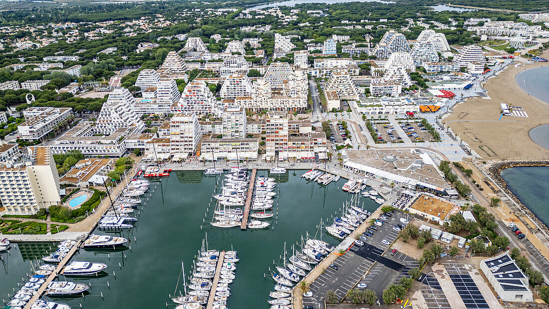 Aerial of the sport harbour, futuristic seaside town of La Grande Motte, Herault, Occitania, France, Europe