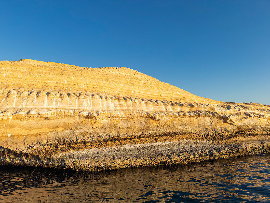 Sandstone cliff formations at sunrise on Isla San Jose, Baja California Sur, Sea of Cortez, Mexico, North America