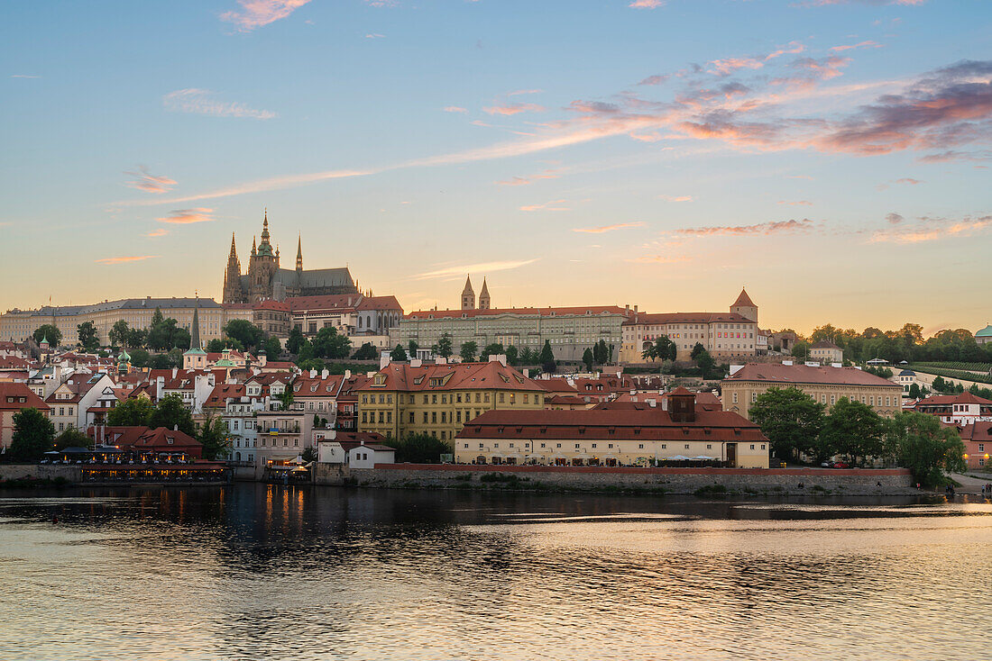 Prague Castle rising above Vltava River at sunset, UNESCO World Heritage Site, Prague, Bohemia, Czech Republic (Czechia), Europe