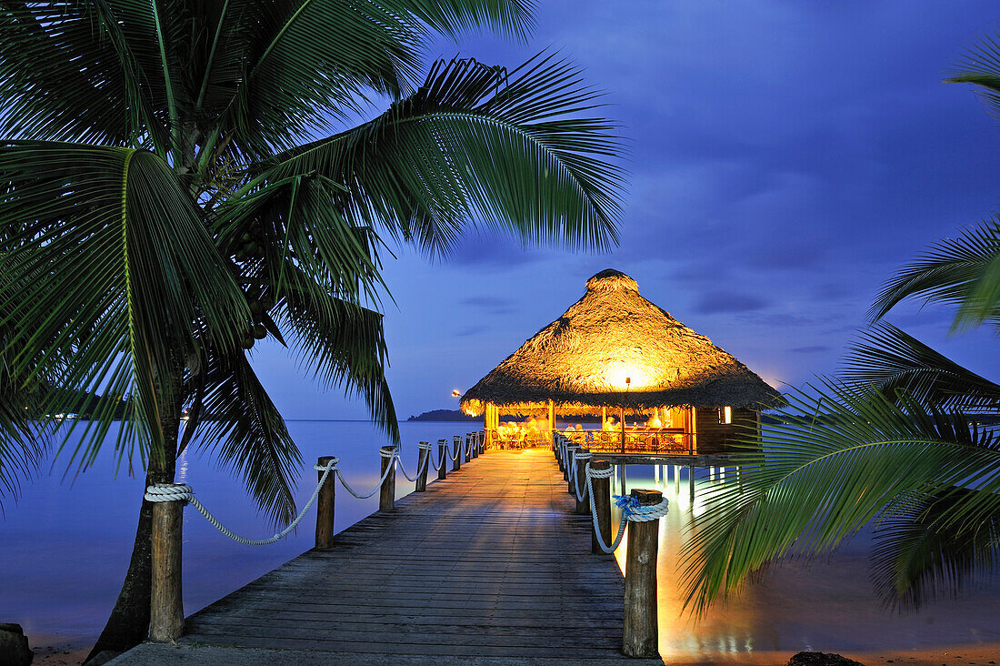 Bar and restaurant on stilts at dusk, Playa Tortuga hotel, Colon Island, Bocas del Toro Archipelago, Republic of Panama, Central America