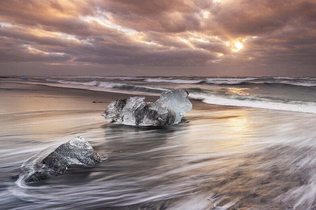 A block of ice deposited on Diamond Beach near the famous Jokusarloon Glacier Lagoon, on a winter morning, Iceland, Polar Regions