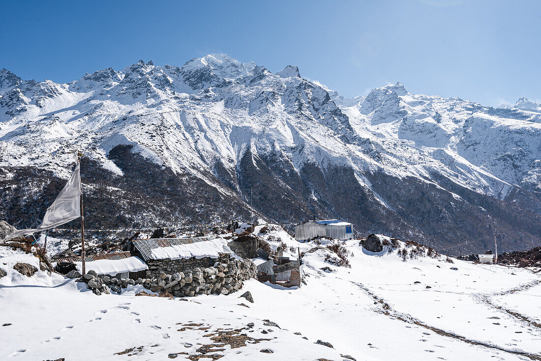 Steinmauern im Schnee und verschneite Bergketten, Kyanjin Gompa, Langtang Valley Trek, Himalaya, Nepal, Asien