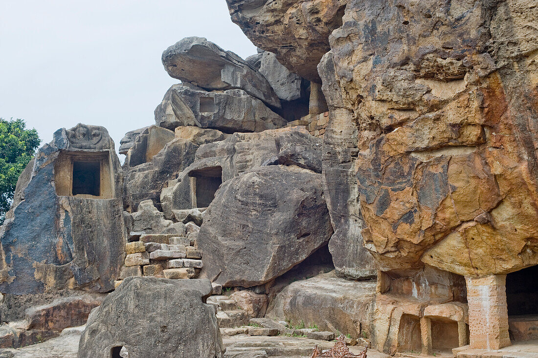 Monks' cells cut into the hillside rock among the Udayagiri and Khandagiri caves dating back to over 100 years BCE sculpted as religious retreats for Jain devotees, Bhubaneswar, Odisha, India, Asia