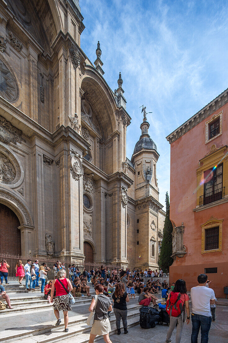 A beautiful view of the historic Catedral in Granada, España, with tourists gathered on a sunny day. The stunning architecture and vibrant atmosphere are showcased.