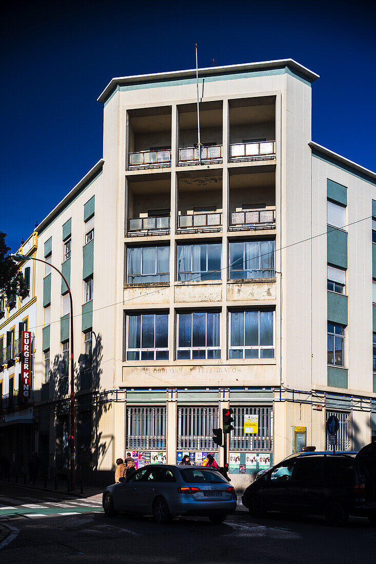 A modern view of the former Correos building, located in Triana, Sevilla, España. Captured in daylight with street traffic.