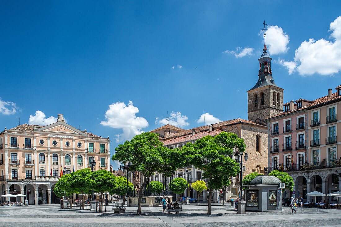 View of Juan Bravo Theatre and San Miguel Church located in Plaza Mayor in Segovia, Castilla y Leon, Spain. Beautiful architectural landmarks under a clear blue sky.