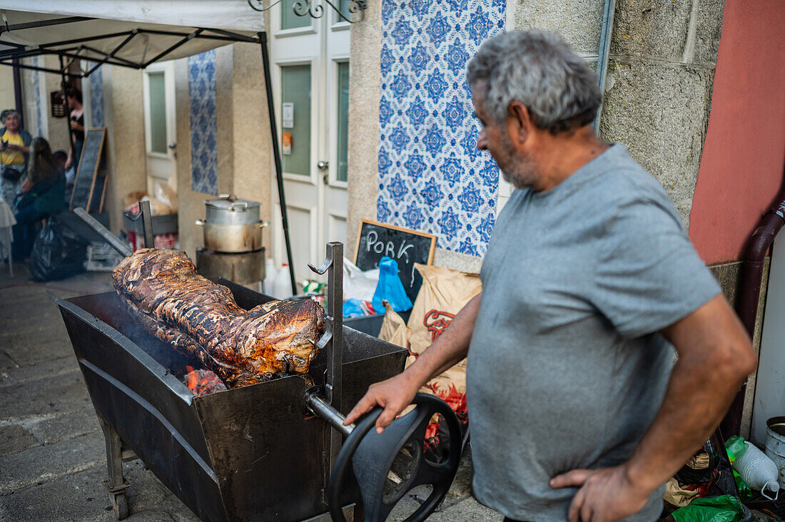 Traditional roasted pork sandwich at Festival of St John of Porto (Festa de São João do Porto ) during Midsummer, on the night of 23 June (Saint John's Eve), in the city of Porto, Portugal