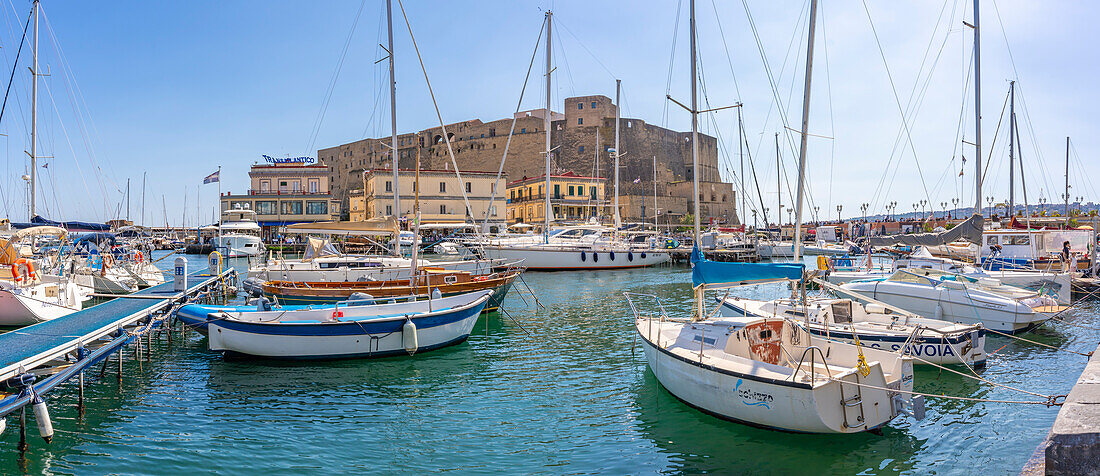 View of boats in harbour and Ovo Castle, historic centre, UNESCO World Heritage Site, Naples, Campania, Italy, Europe