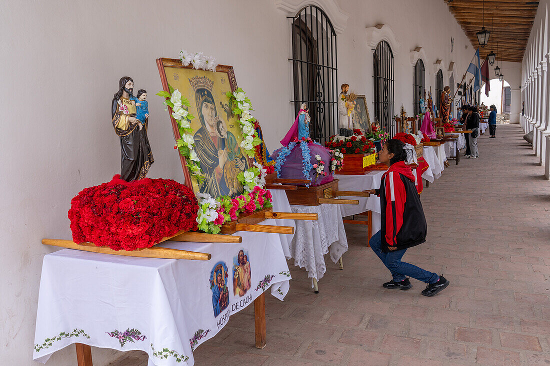 Parishioners venerate religious statues and icons on display before the procession on Saint Joseph's Day in Cachi, Argentina.