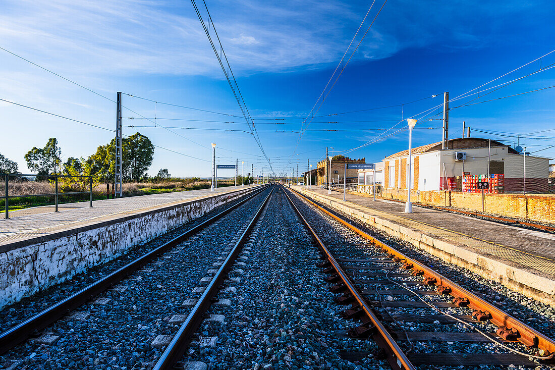 Peaceful view of an empty railway station in the town of Carrion de los Cespedes, Sevilla, Andalusia, Spain, during a sunny day.