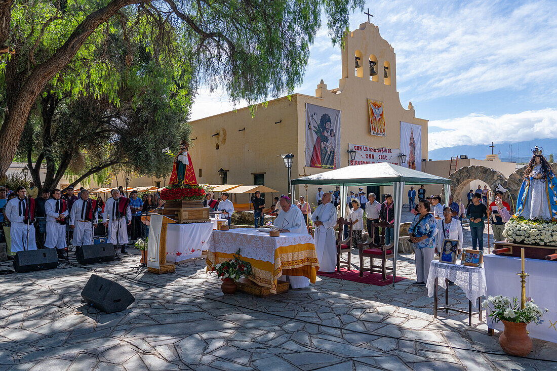 A priest delivers a message in the plaza at the festival of Saint Joseph's Day in Cachi, Argentina.