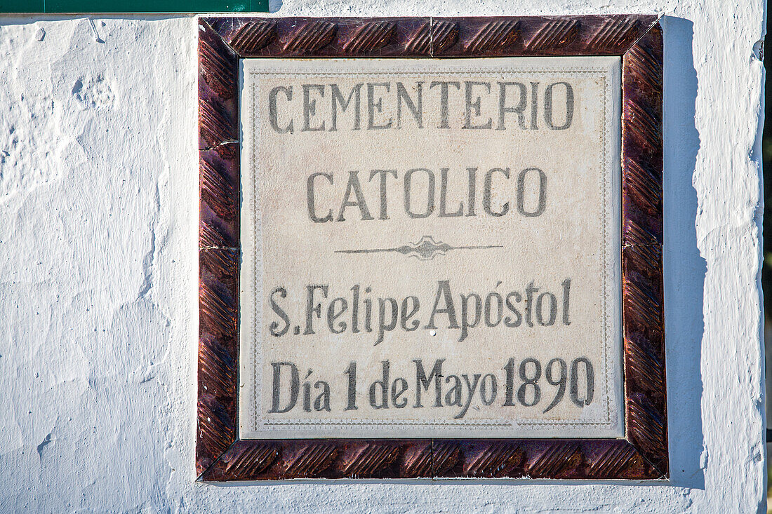 Close up of a historic Catholic cemetery sign dated May 1, 1890, in Aznalcazar, Seville, Andalucia, Spain. A significant cultural and religious landmark.