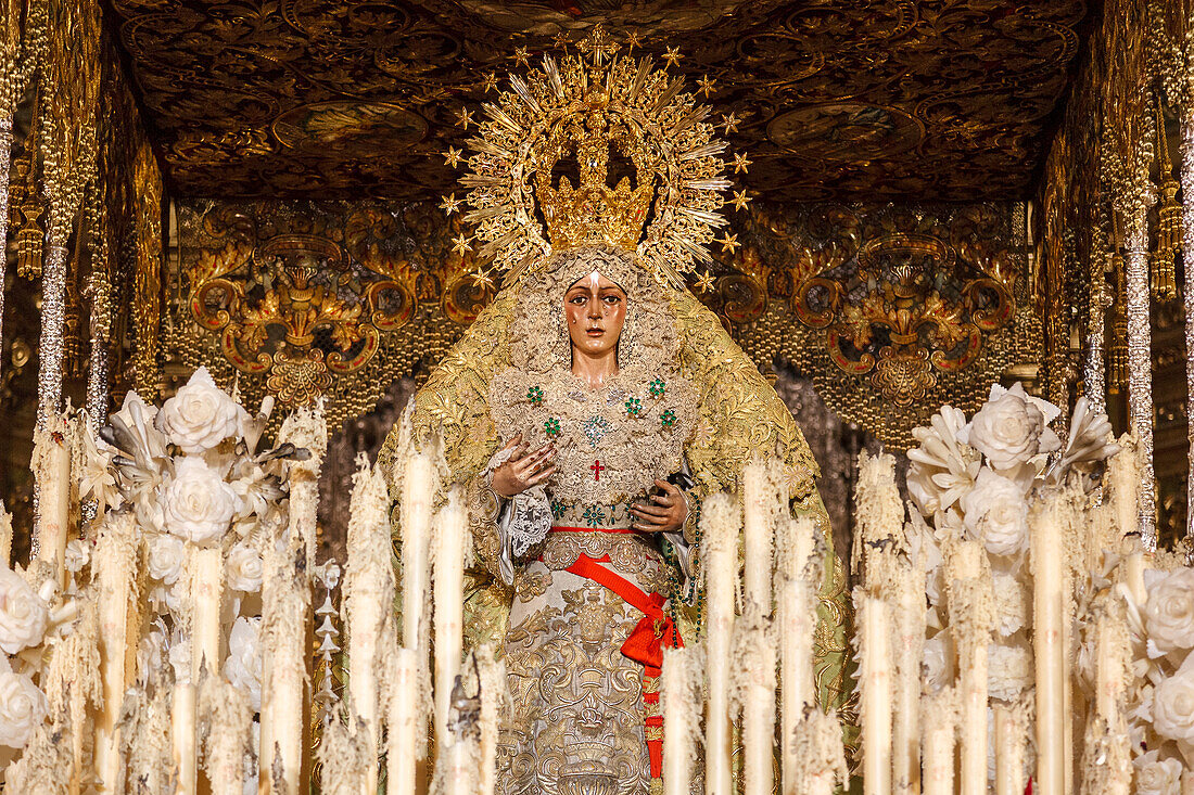 The Virgin of Hope Macarena adorned with candles after the Good Friday procession during the Semana Santa celebration in Seville, Spain.