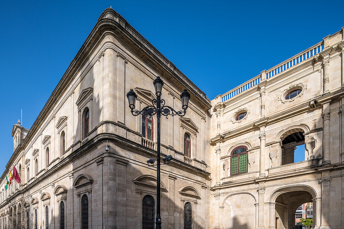 Exterior view of the historic Ayuntamiento de Sevilla, bathed in daylight. Showcasing beautiful architecture in Seville, Spain.