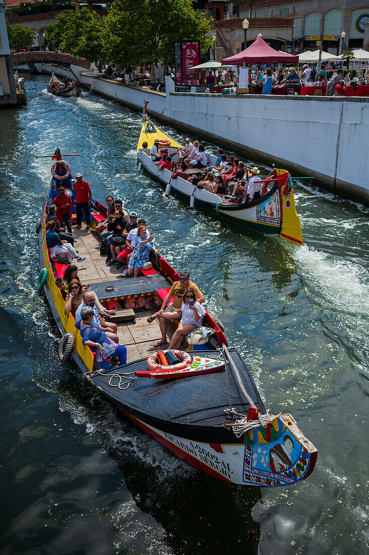 Boat ride through canals in a colorful and traditional Moliceiro boat, Aveiro, Portugal