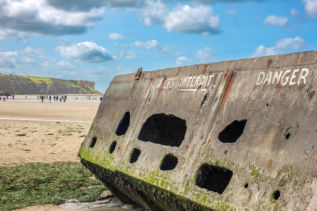 Remains of the historic Mulberry B at Gold Beach in Arromanches, Normandy, France, showcasing D-Day legacy.