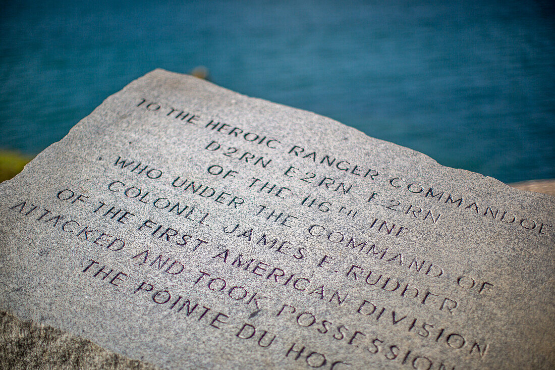 Close-up of a plaque honoring Ranger Commandos at Pointe du Hoc in Normandy, France. Memorial of World War II heroism.