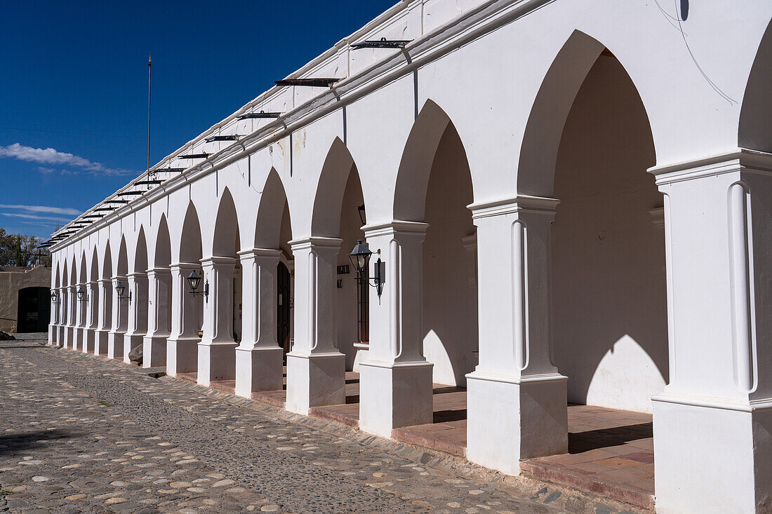 The arched arcade of the Pio Pablo Diaz Arqueological Museum on the main plaza in Cachi, Argentina.