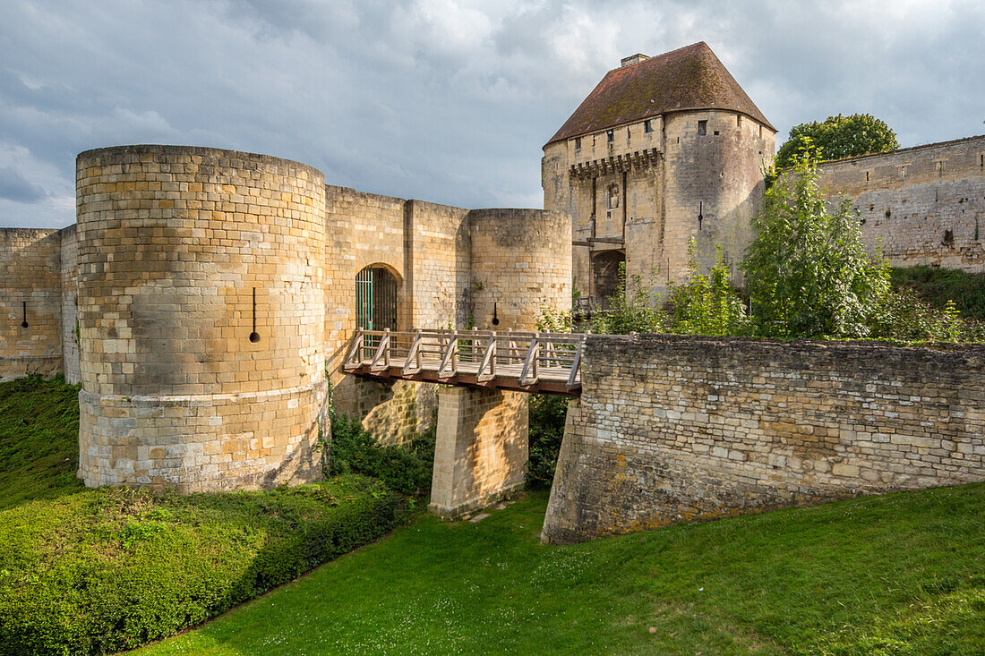 An enchanting view of the historic Castle of Caen in Normandy, France, with Saint Pierre Church in the background, showcasing medieval architecture.