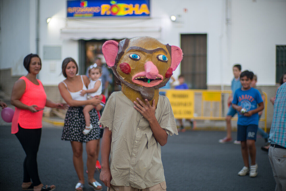 People celebrating the Gigantes y Cabezudos festival in Fuenteheridos, Huelva, Andalucia, Spain. Traditional cultural event with costumed characters and crowds enjoying festivities.