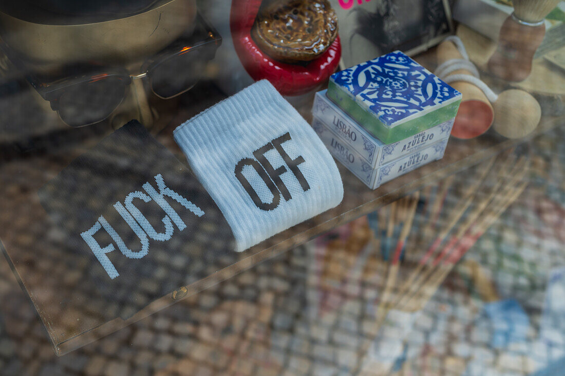 Socks with the slogan Fuck Off embroidered on display window, Aveiro, Portugal