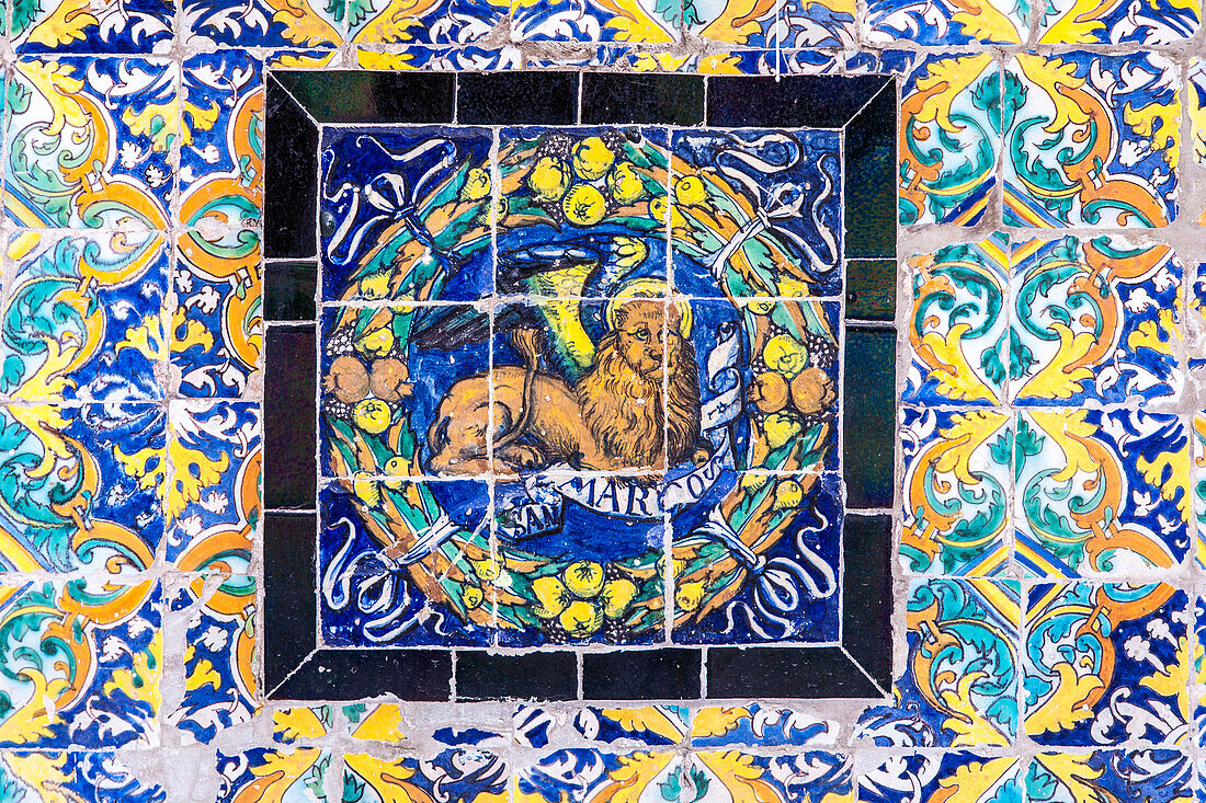 The Saint Mark emblem depicted in colorful glazed ceramic tiles at the Fine Arts Museum in Seville, Spain.