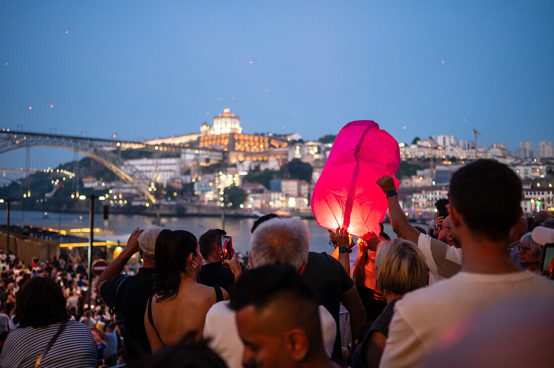 Hot air balloons launching over Luis I bridge and Douro River during Festival of St John of Porto (Festa de São João do Porto ) during Midsummer, on the night of 23 June (Saint John's Eve), in the city of Porto, Portugal