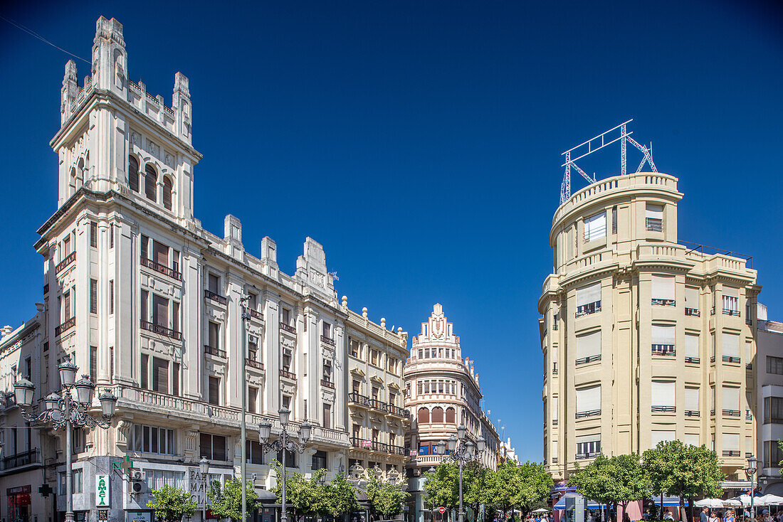 Early 20th-century modernist architecture in Plaza de las Tendillas, Cordoba, Spain. Showcasing beautiful historic buildings under a clear blue sky.