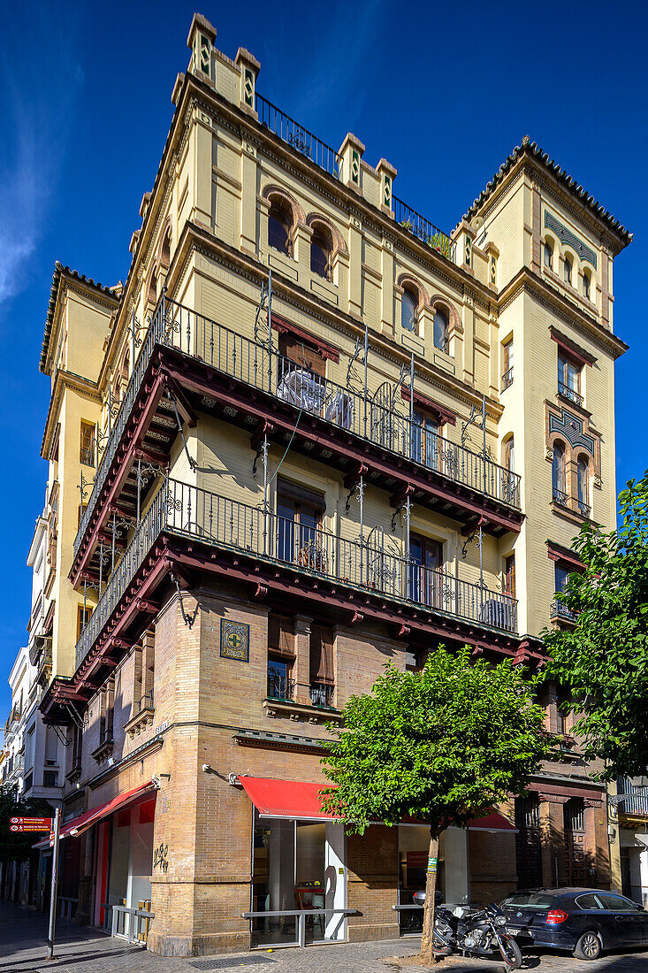 Historic regionalist building designed by architect José Espiau in 1921 located on Calle Feria, Seville. Captivating architecture displaying early 20th century Spanish urban design.