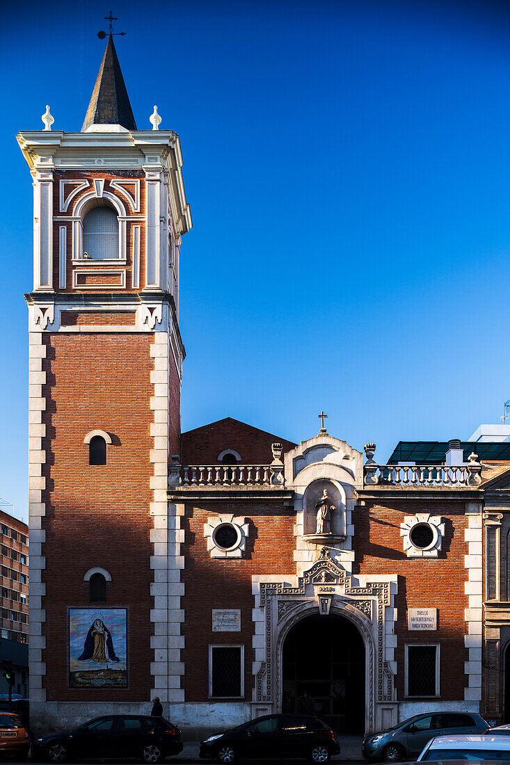 Beautiful 20th-century Iglesia de San Vicente de Paul in the vibrant Triana district of Sevilla, Spain, under a clear blue sky.