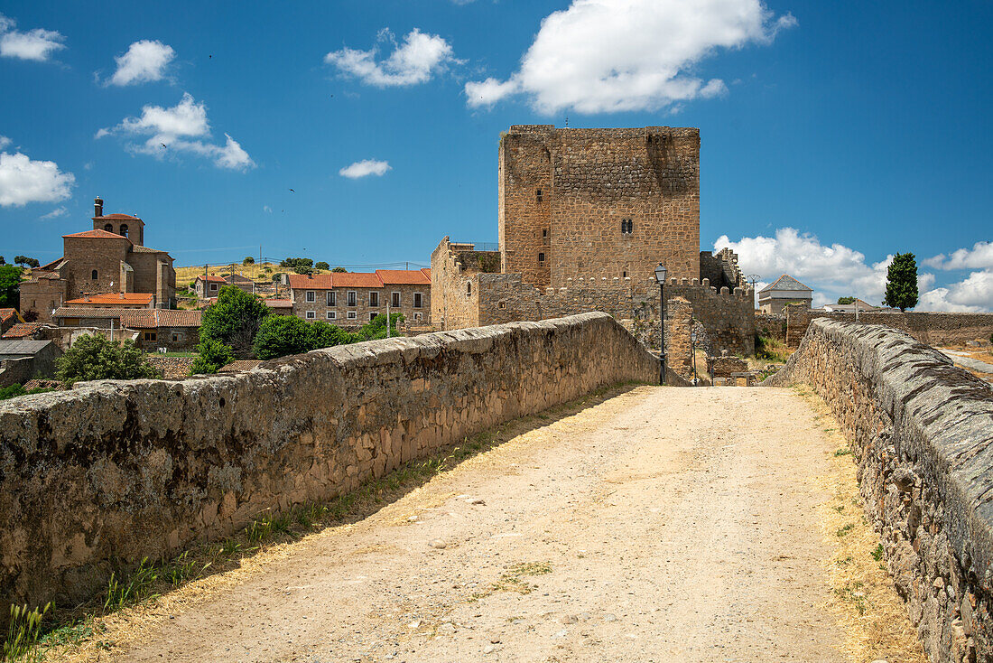 Scenic view of the medieval bridge over the Tormes River and Davila Castle in Puente del Congosto, Salamanca, Spain.