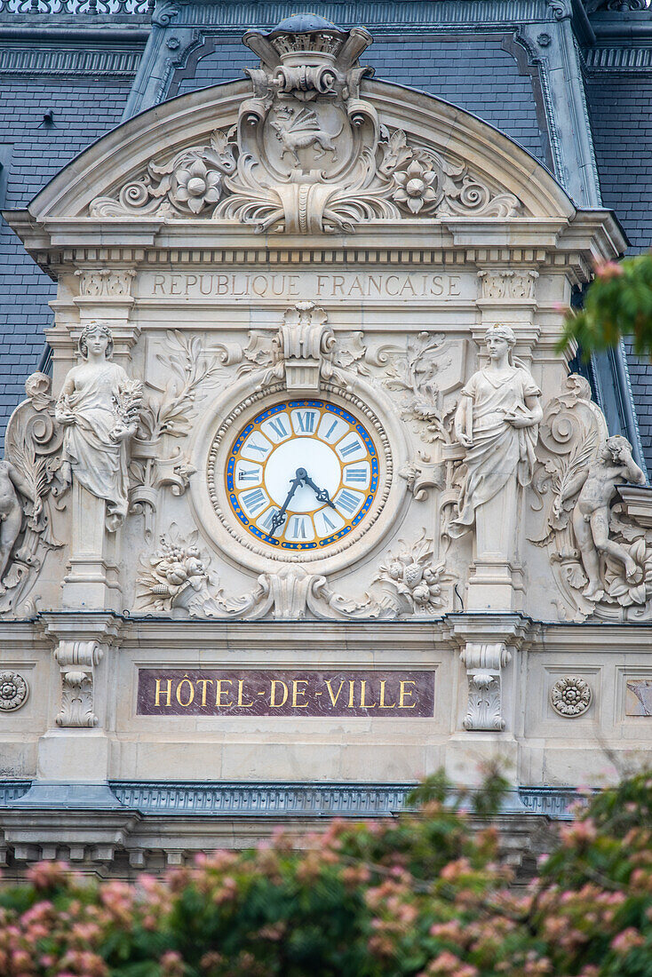 Detailed facade of Hotel De Ville in Vannes, Brittany, France, showcasing ornate architecture with a prominent clock.