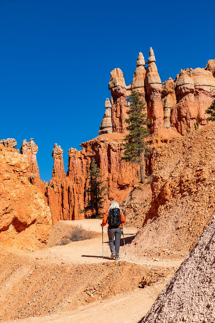 Rear view of woman with backpack hiking in Bryce Canyon National Park