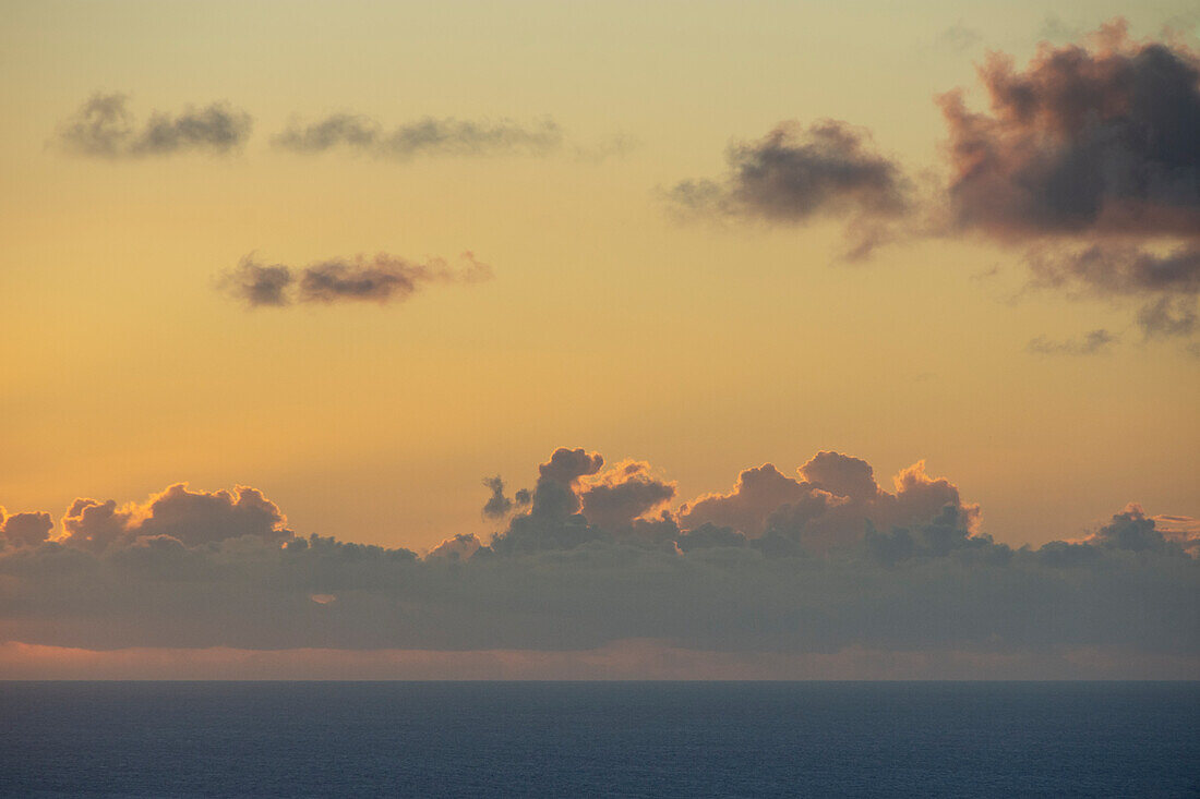 Clouds above calm ocean at sunrise