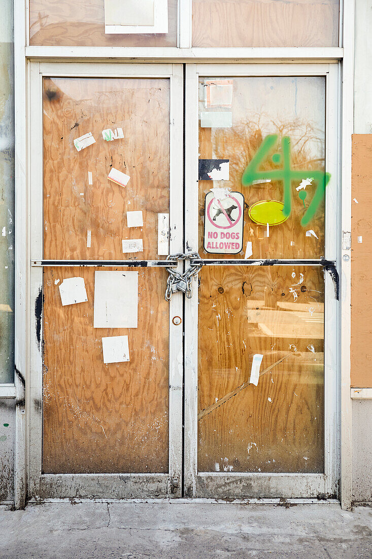 Chain and padlock on boarded up door