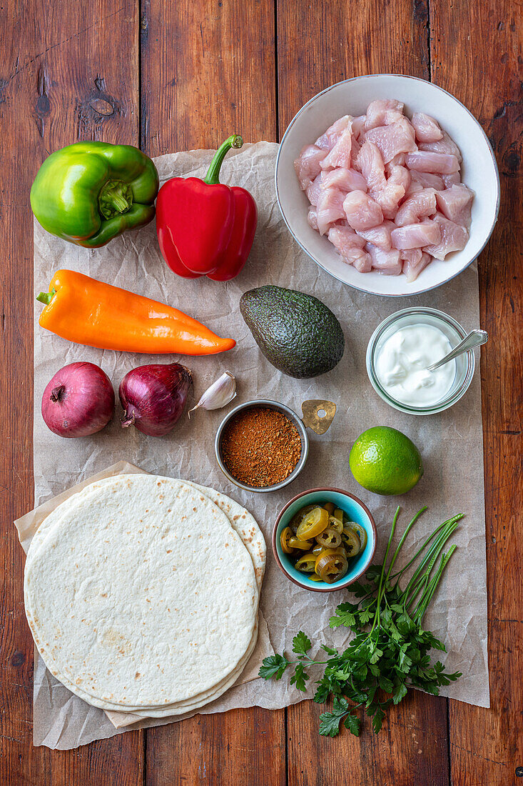 Ingredients for fajitas with turkey fillet, peppers and avocado