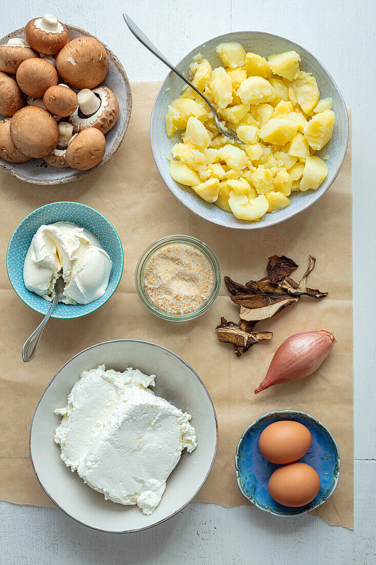 Ingredients for potato and quark cakes with mushroom cream sauce