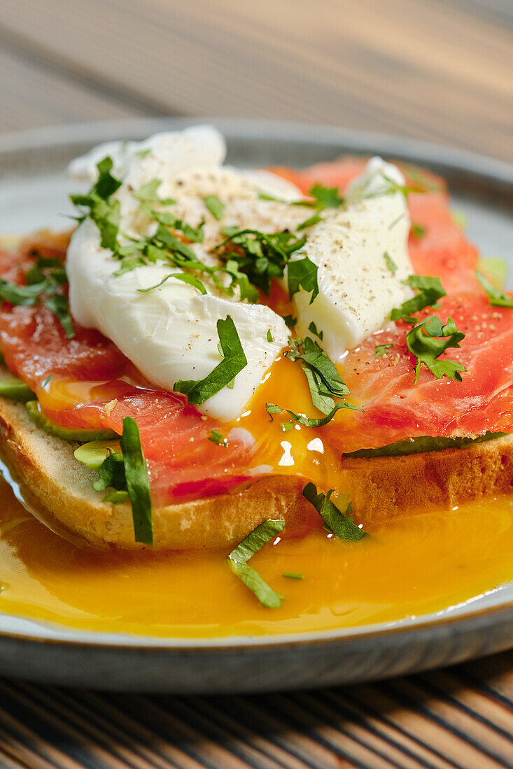 Smoked trout sandwich with avocado and poached egg