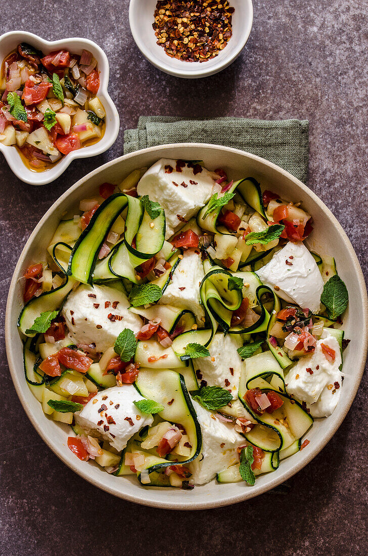 Zucchini carpaccio with mozzarella and tomato and mint salsa