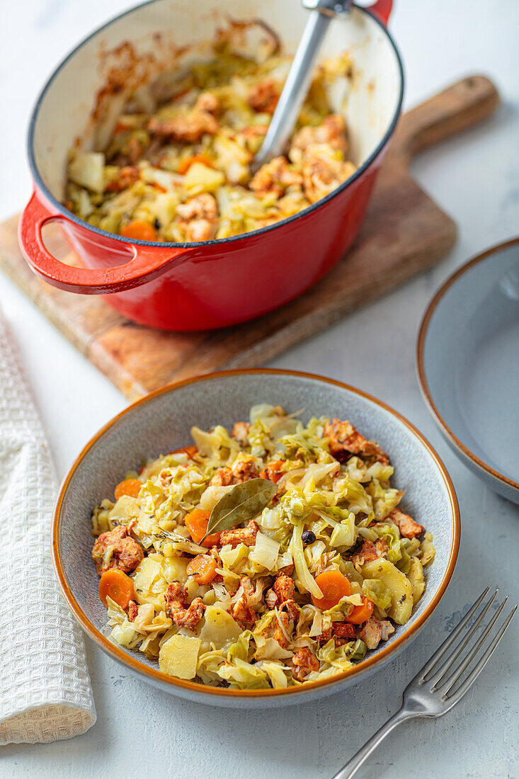 Potato and cabbage stew with carrots and chicken