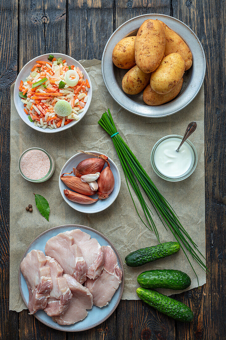 Ingredients for pork chops with vegetables, mashed potatoes and cucumber salad