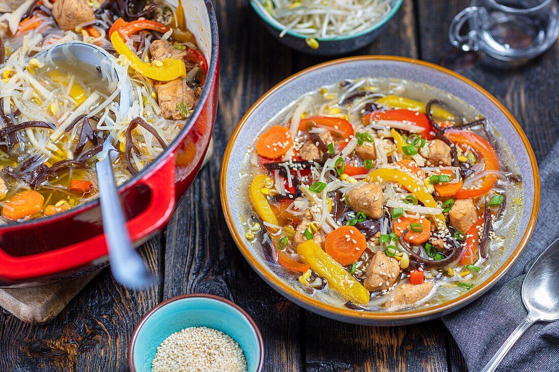 Hot and sour chicken soup with vegetables and soy noodles